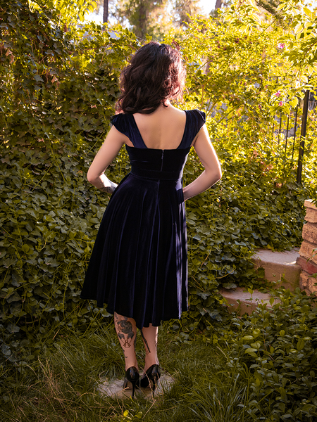 The back of the Baudelaire Swing Dress in Midnight Blue modeled by Stephanie for goth clothing company La Femme en Noir.
