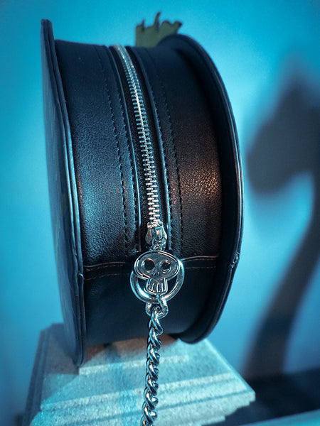 The zippered closure of the BEETLEJUICE™ Beetlesnake Crossbody Bag from goth glamour clothing brand La Femme en Noir.