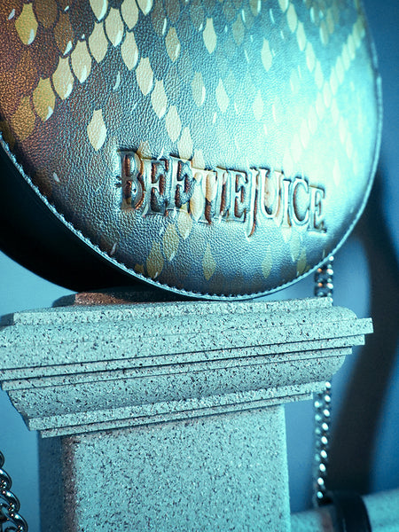 Close-up of the Beetlejuice imprinted logo on the BEETLEJUICE™ Beetlesnake Crossbody Bag.
