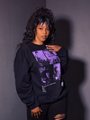 Female model shot in a grey room while wearing the Ghost Sweatshirt from gothic clothing brand La Femme en Noir.