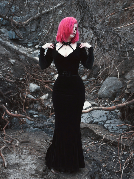 A full length shot of Mackenzie modeling the Black Marilyn gown in black paired with a harness.