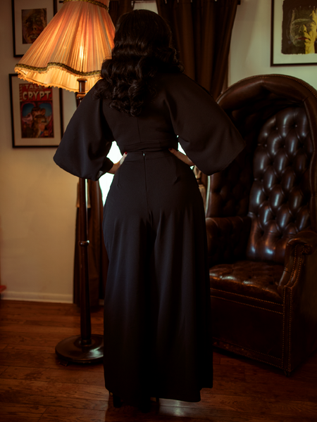 Rachel Sedory showing off the backside of the Black Widow Palazzo Pants in Black from gothic vintage clothing retailer and maker La Femme en Noir.