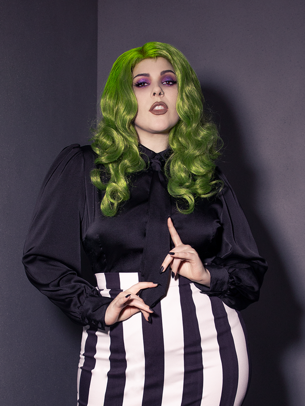 Close up of a female model holding the tie on the Bowie Blouse w/Matching Tie in Black Charmeuse from La Femme en Noir.