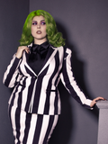 Female model wearing the Bowie Blouse w/Matching Tie in Black Charmeuse with black and white striped jacket and skirt channeling her inner Beetlejuice.