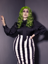 Green haired model wearing the Bowie Blouse w/Matching Tie in Black Charmeuse tucked into a black and white striped skirt.