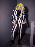 Full length shot of Micheline Pitt providing a glimpse of the Beetlejuice inspired outfit she's rocking including black and white striped jacket, pants and the all-new Bowie Blouse w/Matching Tie in Black Charmeuse.