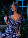 Vanessa posing in a garden area outside while wearing the Tim Burton's CORPSE BRIDE™ Emily Butterfly Headband from retro gothic clothing company La Femme en Noir.