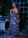 With her hand placed on her chest, Vanessa turns her head to the side while wearing Tim Burton's CORPSE BRIDE™ Butterfly Maxi Dress in Dusk Blue.