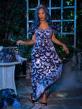 Vanessa caught in motion walking towards the camera while wearing Tim Burton's CORPSE BRIDE™ Butterfly Maxi Dress in Dusk Blue.