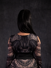 A back view of Jyoti modeling the Corset Belt in Black Faux Leather.