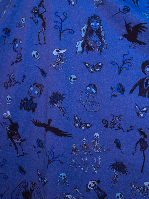 A close up of the pattern on the fabric of the  Tim Burton's CORPSE BRIDE™ Beyond the Veil Dress in Novelty Print featuring characters from the beloved film.