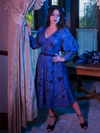 Ashley posing in an old Victorian home that matches her  Tim Burton's CORPSE BRIDE™ Beyond the Veil Dress in Novelty Print from La Femme en Noir.