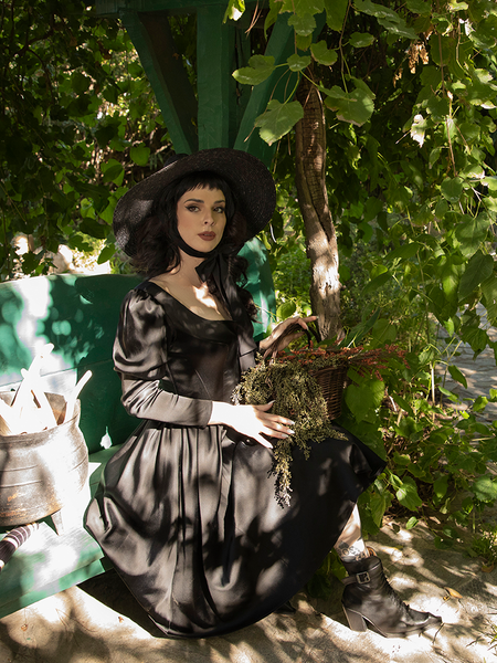 The Cottage Witch Dress in Japanese Black Satin from gothic glamour clothing company La Femme en Noir as worn by Stephanie Joens.