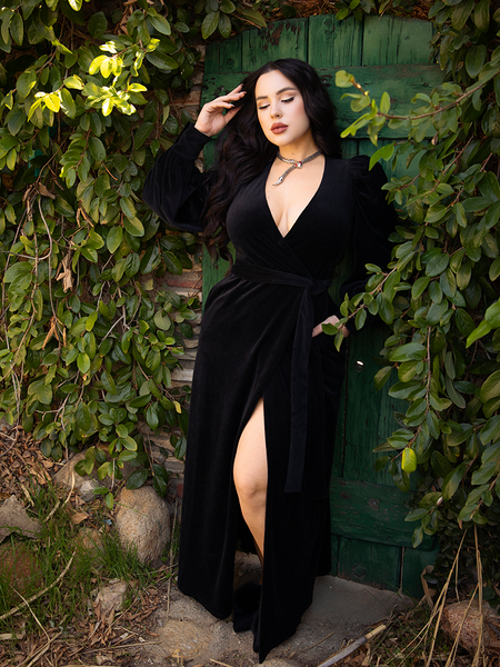 Rachel Sedory posing in the Crawford Hostess Wrap Gown in Black.