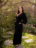 The Crawford Hostess Wrap Gown in Black being worn by Rachel Sedory.