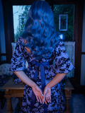 The back of Tim Burton's CORPSE BRIDE™ Butterfly Babydoll Dress in Dusk Blue being worn by a baby-blue haired Vanessa from goth dress company La Femme en Noir.