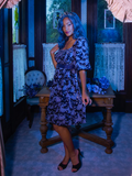 Profile shot of Vanessa posing in the Tim Burton's CORPSE BRIDE™ Butterfly Babydoll Dress in Dusk Blue from goth retro clothing company La Femme en Noir.
