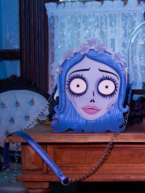 Tim Burton's CORPSE BRIDE™ Emily Bag photographed in front of a white floral window curtain.