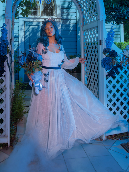 Vanessa offers a view of the blue rose bouquet in her hand while modeling an ornately decorated gothic style dress from La Femme en Noir.