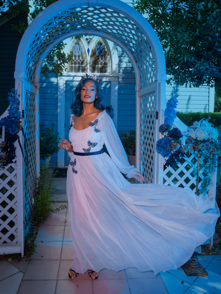 Tim Burton's CORPSE BRIDE™ Emily Butterfly Gown in Celestial Blue blows gently while being worn by goth clothing model Vanessa. 