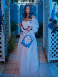 Tim Burton's CORPSE BRIDE™ Emily Butterfly Gown in Celestial Blue paired with matching Emily bag - items worn by gothic style clothing model and made by La Femme en Noir.