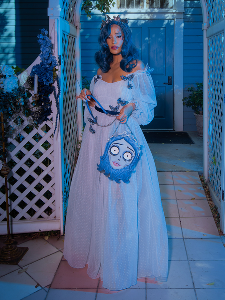 Vanessa holding the Corpse Bride Emily bag while also wearing Tim Burton's CORPSE BRIDE™ Emily Butterfly Gown in Celestial Blue.