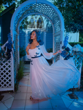 The skirt of Tim Burton's CORPSE BRIDE™ Emily Butterfly Gown in Celestial Blue flutters in the wind while being worn by Vanessa from La Femme en Noir.