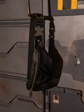 The ALIEN Xenomorph Hip Bag hanging from an iron rod protruding from the wall.