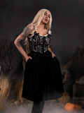 Micheline Pitt looks into the camera while modeling the Sleepy Hollow Gothic Tales Velour Skirt in Black from La Femme En Noir.