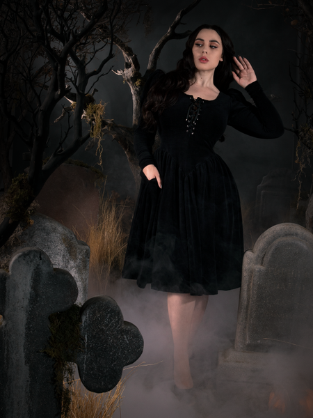 Model Rachel Sedory wearing the Sleepy Hollow Gothic Tales Velour Dress in a gothic scene.
