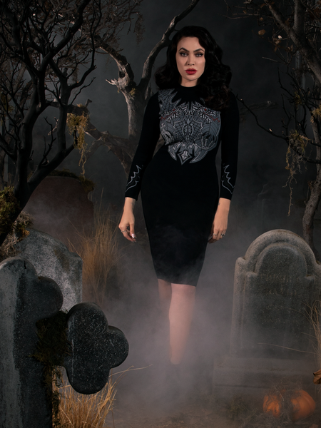 Full length shot of Micheline Pitt wearing a black gothic dress inspired by the Sleepy Hollow movie.