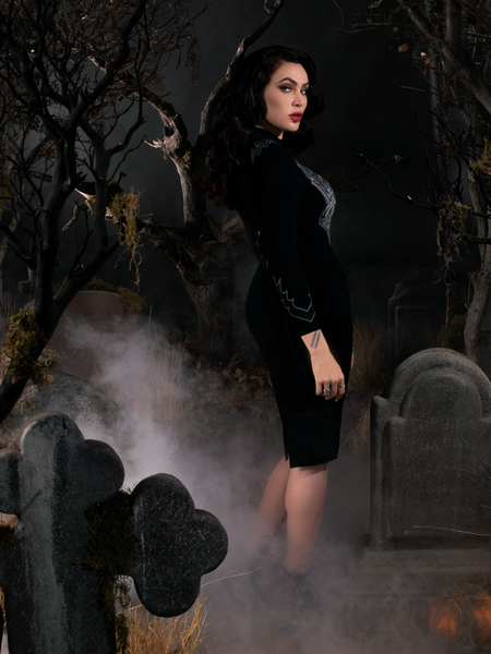 Profile shot of Micheline Pitt modeling the Sleepy Hollow Hessian Dress in Black from gothic dress maker La Femme en Noir.