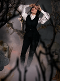 Micheline Pitt standing in a foggy cemetery while wearing the Sleepy Hollow Ichabod Pants in Black from La Femme en Noir.
