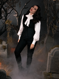 Micheline Pitt standing in a foggy cemetery while wearing a goth style clothing outfit including the Sleepy Hollow Ichabod Pants in Black.