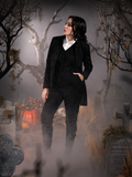 Micheline Pitt turned to her right with a hand tucked into the pocket of her Sleepy Hollow Ichabod Pants in Black.