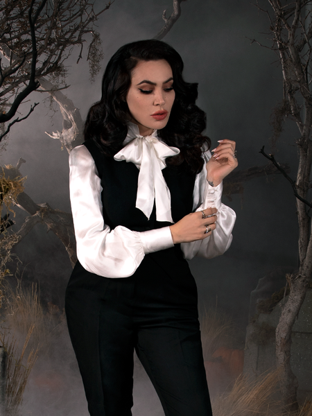 Micheline Pitt, adjust the sleeves on her Victorian Blouse in Ivory from gothic clothing company La Femme en Noir.