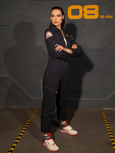 KJ standing with her arms crossed while wearing the ALIEN Ripley Flight Suit in Navy.