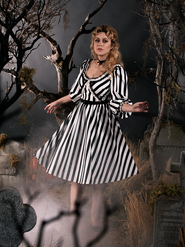 Linda spinning around in her gothic retro outfit.