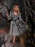 Full length gothic dress worn by Linda standing in a gothic graveyard.