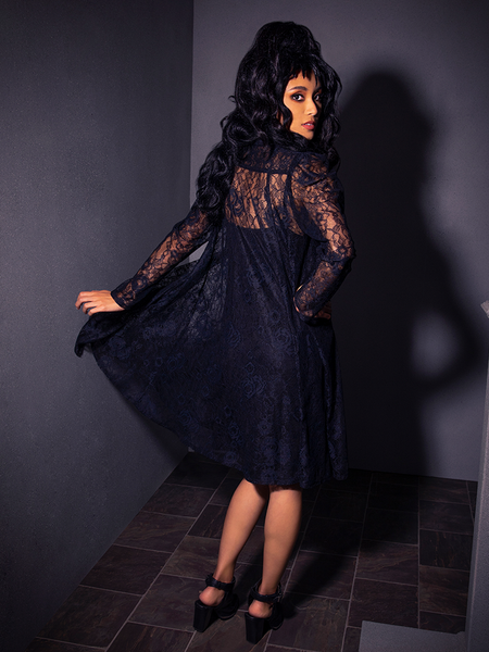 In La Femme en Noir's BEETLEJUICE™ Darkroom Dress, this female model looks absolutely gorgeous.