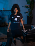 Full length shot of female model standing in a dimly lit waiting room area while wearing the BEETLEJUICE™ Lydia Dead Tee.