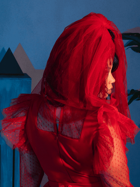 The back of the Tulle Veil in Red being worn by female model.