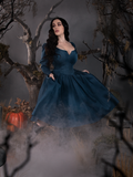 Rachel strolls through a foggy cemetery while modeling the  Sleepy Hollow The Lady Crane Dress in Vintage Blue from La Femme en Noir.