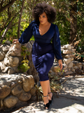 Walking through an outdoor, wilderness environment Ashleeta shows off the Vamp Pencil Skirt in Navy from gothic glamour clothing band La Femme en Noir. 