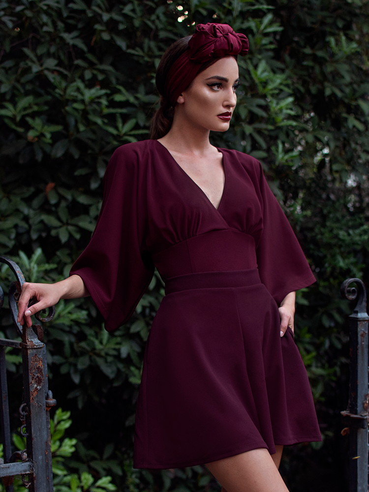 Aliza, looking away from the camera, models the Black Widow tap shorts in oxblood by La Femme En Noir.