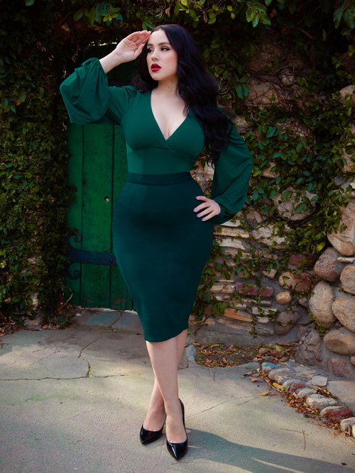 Full length shot of Rachel in a classically gothic retro outfit including the Vamp Pencil Skirt in Dark Green.