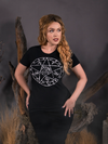 With her hands on her hips while she looks away from the camera, Linda shows off her goth inspired outfit highlighted by the the Sleepy Hollow™ Protection Spell Tee by La Femme En Noir.