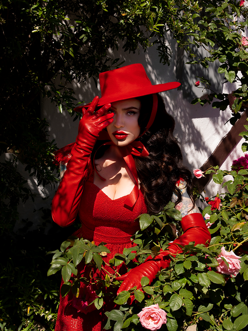 Micheline Pitt modleing the Boleroo Hat in Crimson in an all crimson red outfit from La Femme en Noir.