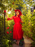 Ashley looking upwards while wearing the Mourning Dress in Crimson Lace with matching sun hat to pull together the perfect gothic glamour outfit.