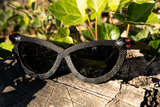 Close up image of the Serpent Sunglasses in Black from La Femme en Noir.